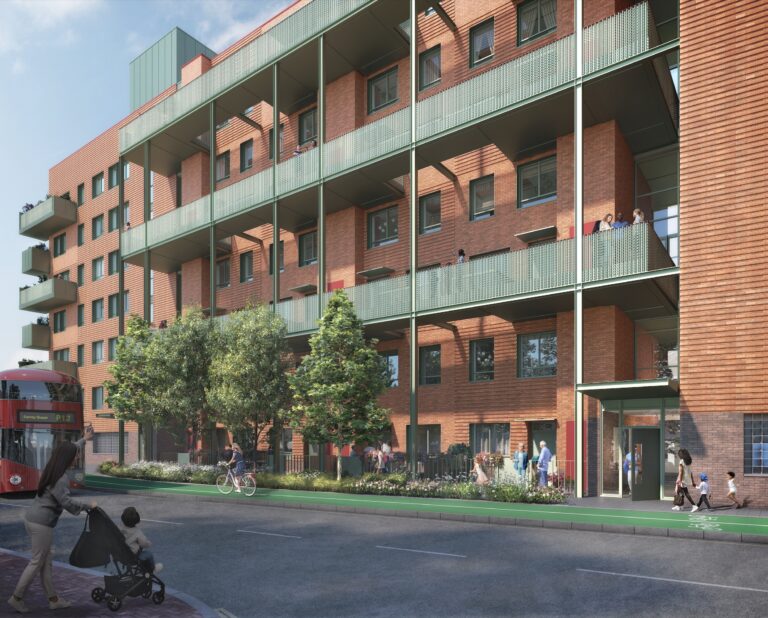 A modern brick apartment with green balconies and a landscaped entrance; people walk and cycle along the sidewalk, with a red bus passing by.