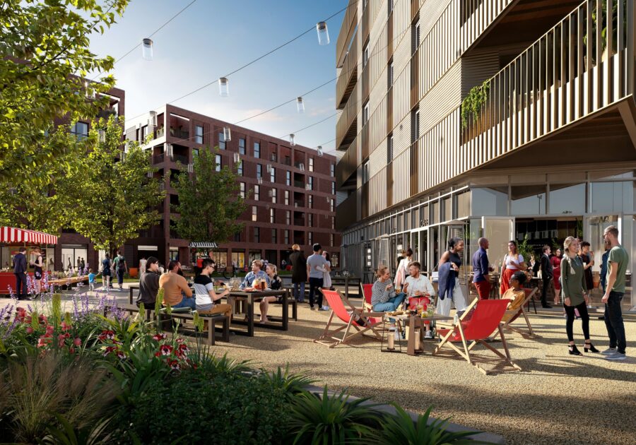An outdoor communal space with cafes and people, surrounded by modern apartments blocks with a large green space.