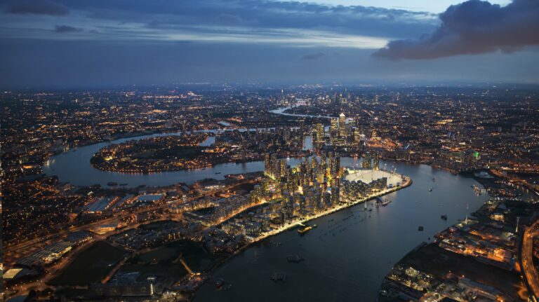 A night birds eye view of Greenwhich with all the buildings lighten up and the River Thames.
