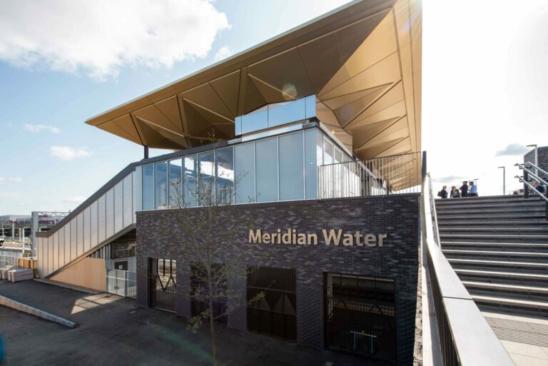 The Merdian Water train station, modern in black and gold with communal foot paths.