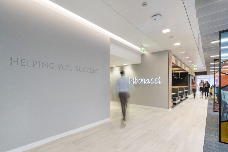 Indoor scene featuring a clean and well-designed space with a focus on the wall, ceiling, and floor, complemented by artistic decor.