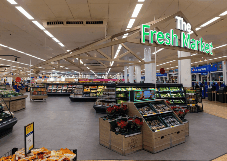 Inside Tesco's Fresh Market section with fruits and vegetables.