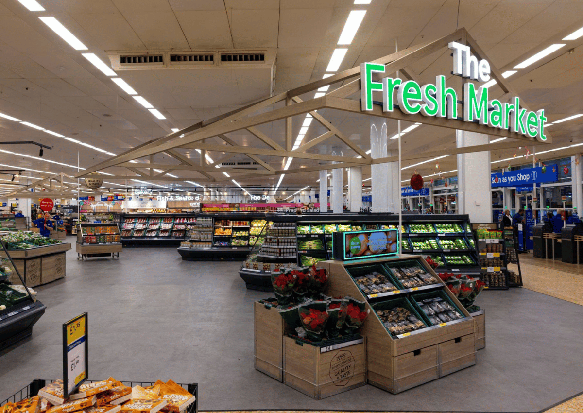 Inside Tesco's Fresh Market section with fruits and vegetables.