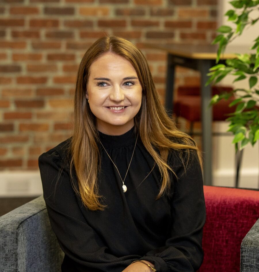 Woman in corporate wear sitting on red chair