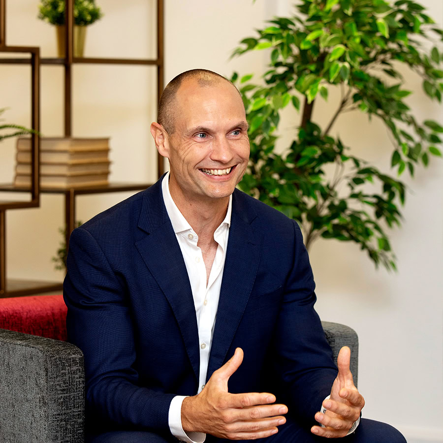 Man smiling sitting on chair.
