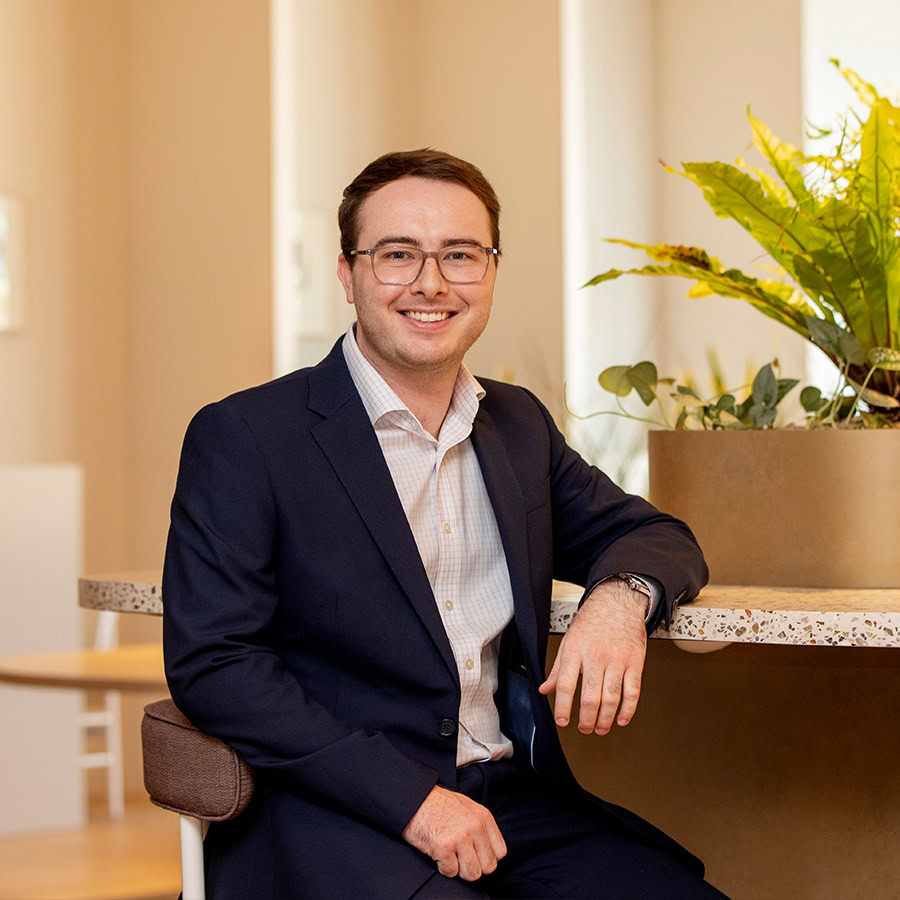 Photo of a man in a suit smiling.