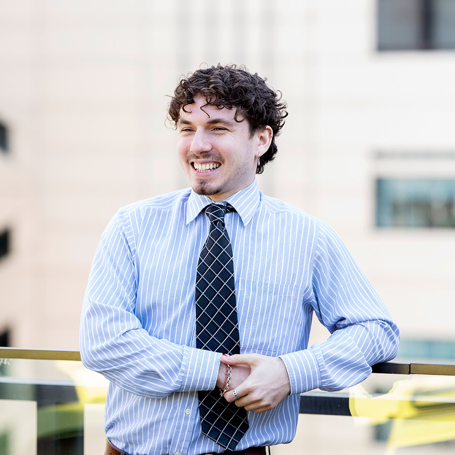 Man smiling on rooftop.