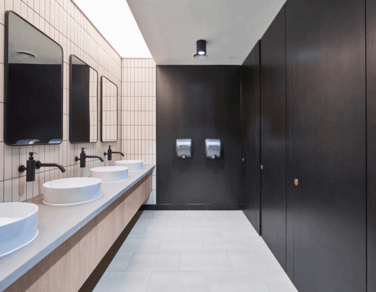 Toilet inside office building, with mirrors, sinks, taps and doors.