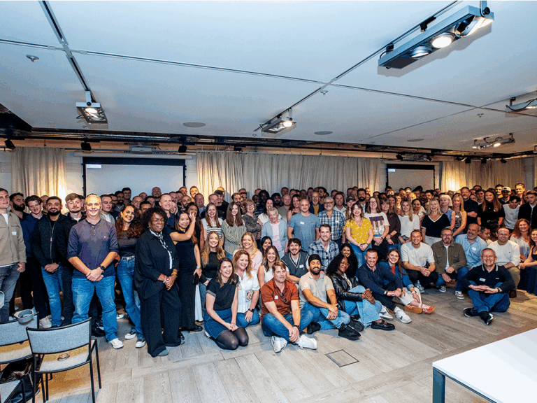 Large group of people sitting in conference room